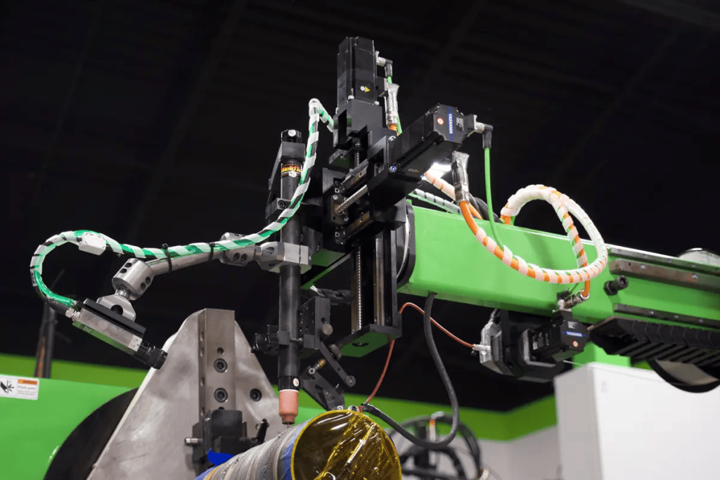 Automated pipe welding machine in action welding pipe spools in an industrial fabrication shop